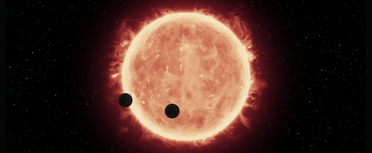 Artist’s illustration of two Earth-sized planets, TRAPPIST-1b and TRAPPIST-1c, passing in front of their parent red dwarf star, which is smaller and cooler than our sun. NASA’s Hubble Space Telescope looked for signs of atmospheres around these planets.