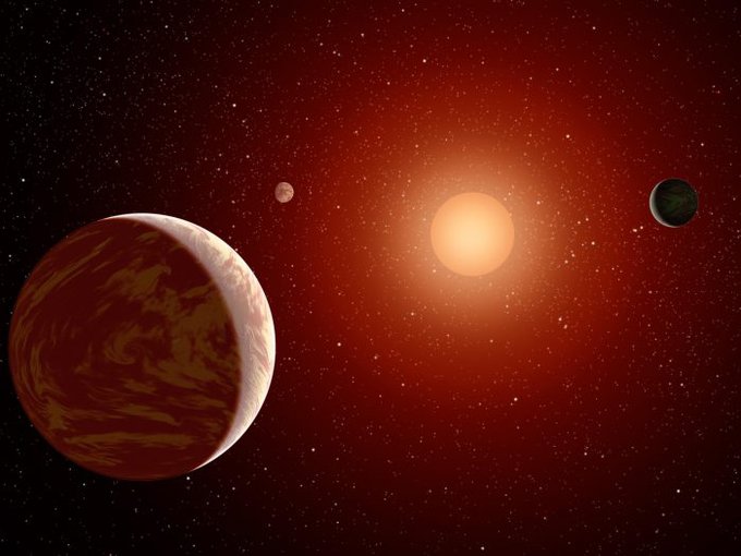 Artist rendering of a red dwarf or M star, with three exoplanets orbiting. About 75 percent of all stars in the sky are the cooler, smaller red dwarfs.