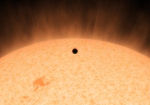 This artist's concept shows the silhouette of a rocky planet, dubbed HD 219134b. At 21 light-years away, the planet is the closest outside of our solar system that can be seen crossing, or transiting, its star.