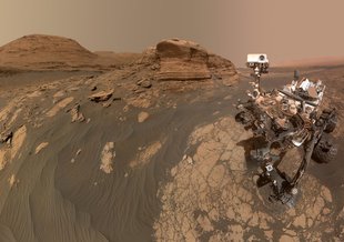Curiosity used two cameras to create this selfie in front of Mon Mercou, a rock outcrop that stands 6 meters tall. The panorama is made up of 60 images from the MAHLI camera on the rover's robotic arm along with 11 images form the Mastcam.