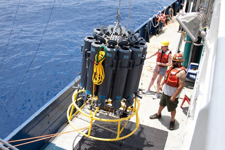 Researchers Liz Robertson from the University of Southern Denmark and Josh Manger from the University of California, San Diego, ready a sample collector. The carrousel of tubes dropped down 1,000 feet to an oxygen minimum zone off Mexico's Pacific coast. Credit: Dr. Heather Olins.