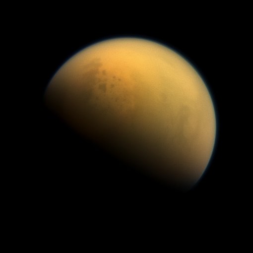 Looking down at Titan with Cassini. Some of the large lakes filled with methane and ethane are visible through the haze.
