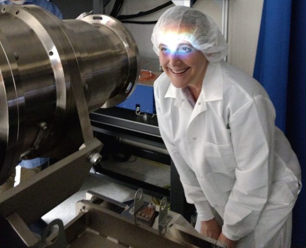 The spectrum from the EXtreme PREcision Spectrometer (EXPRES)  shines on Yale astronomy professor Debra Fischer, who is PI of the project. EXPRES will find many Earth-size planets via the radial velocity method — something that has never been done.