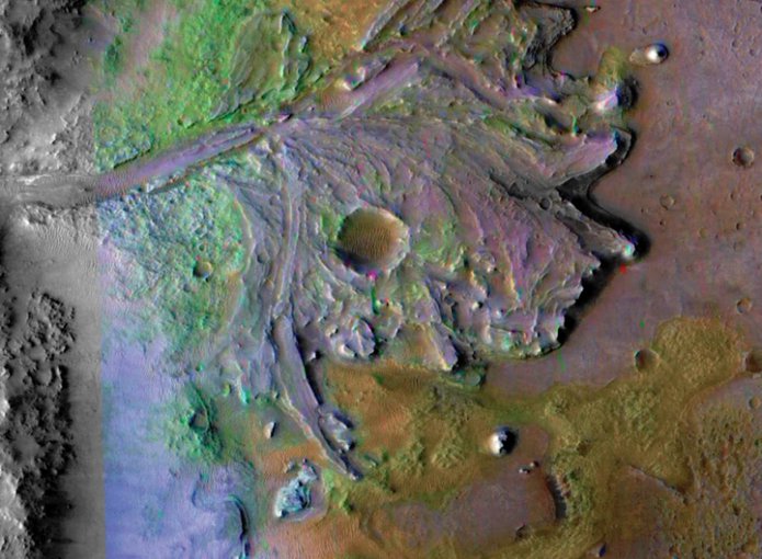 Jezero Crater contains the fossil remains of a river delta and is where the Mars 2020 rover will land.  The image, taken by NASA’s Mars Reconnaissance Orbiter (MRO),  uses non-Martian colors to highlight specific features and mineral deposits.