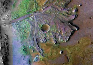 Jezero Crater contains the fossil remains of a river delta and is where the Mars 2020 rover will land.  The image, taken by NASA’s Mars Reconnaissance Orbiter (MRO),  uses non-Martian colors to highlight specific features and mineral deposits.