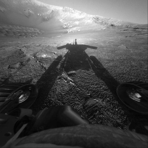 The dramatic image of NASA's Mars Exploration Rover Opportunity's shadow was taken on sol 180 (July 26, 2004) by the rover's front hazard-avoidance camera as the rover moved farther into Endurance Crater in the Meridiani Planum region of Mars.