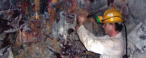 Tullis Onstott of Princeton University opens a borehole in a section of rock wall in a South African mine.