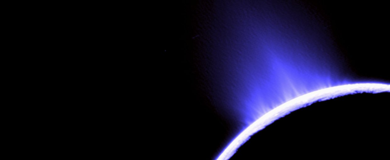This false color photo of water geysers spouting from Saturn’s moon Enceladus was taken by NASA’s Cassini. The geysers establish that there is a subsurface ocean beneath the icy crust of the moon.