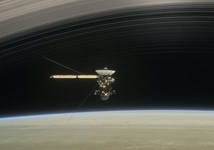 In the still from the short film Cassini's Grand Finale, the spacecraft is shown diving between Saturn and the planet's innermost ring.