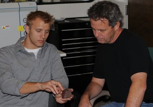 Noah Planavsky (left) and Timothy Lyons are seen here examining a rock sample in the lab. Photo credit: UCR Strategic Communications.