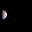 The color image shows atmospheric features on Jupiter, including the famous Great Red Spot, and three of the massive planet's four largest moons -- Io, Europa and Ganymede, from left to right in the image.