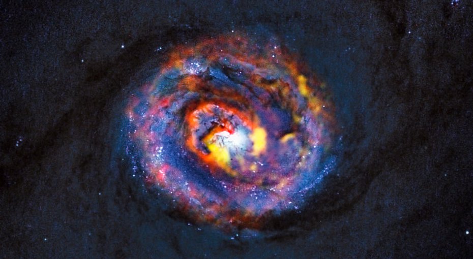 This detailed view shows the central parts of the nearby active galaxy NGC 1433. The coloured structures near the center are from ALMA observations that have revealed a spiral shape, as well as an unexpected outflow, for the first time.