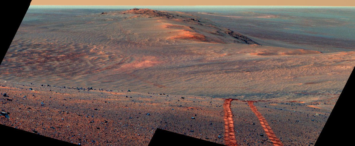 This scene from the panoramic camera (Pancam) on NASA's Mars Exploration Rover Opportunity looks back toward part of the west rim of Endeavour Crater that the rover drove along, heading southward, during the summer of 2014.