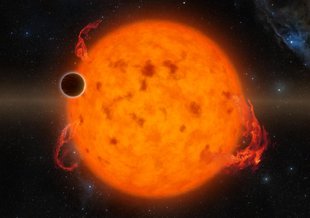 The center of the frame is filled by a bright orange/yellow star. Massive solar flares burst out  and the surface is covered with darker spots. The dark disk of  a transiting exoplanet is seen top left, roughly 1/10 the diameter of the star.