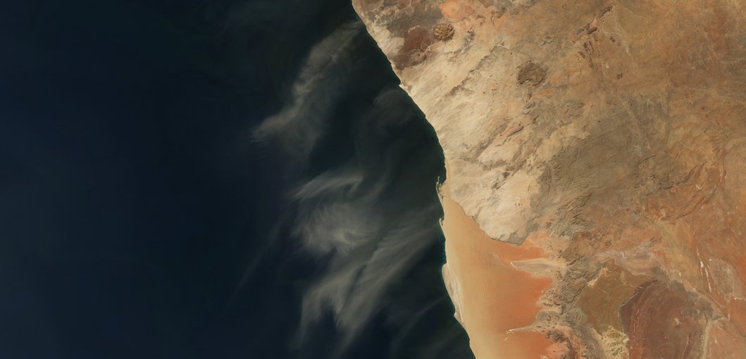 Tendrils of dust swept off the west coast of Namibia and spread over the Atlantic in early July 2005.