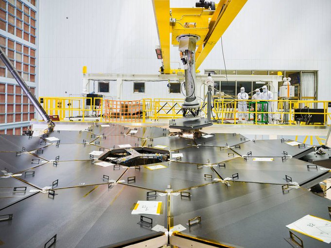 Inside a massive clean room at NASA's Goddard Space Flight Center in Greenbelt, Maryland, the James Webb Space Telescope team used a robotic arm to install the last of the telescope's 18 mirrors onto the telescope structure. Credits: NASA/Chris Gunn