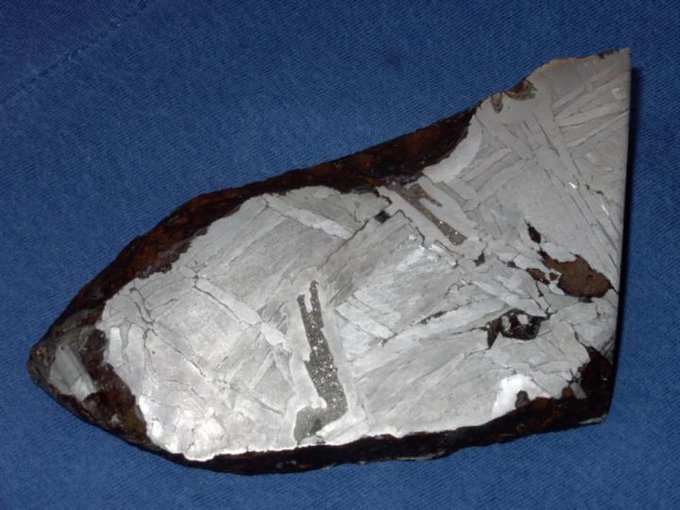 A fragment of the Seymchan meteorite from Russia. The majority of this 6 inch meteorite consists of iron-nickel metal, and the darker-colored structure in the center is schreibersite. Credit: University of South Florida.