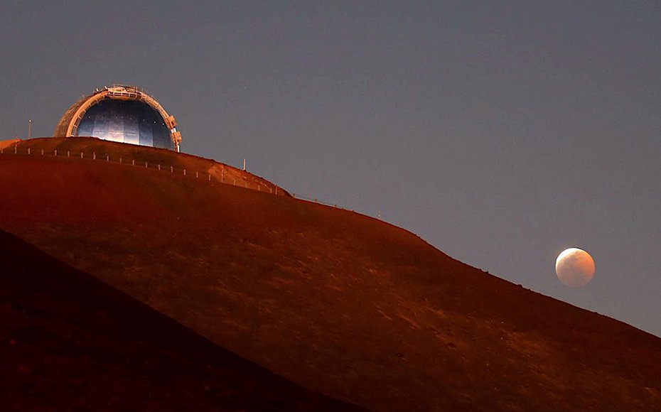 The NASA Infrared Telescope Facility telescope on Maunakea during a lunar eclipse.