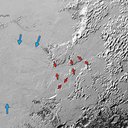 Ice (probably frozen nitrogen) that appears to have accumulated on the uplands on the right side of this 390-mile (630-kilometer) wide image drains from Pluto’s mountains onto Sputnik Planum through the 3- to 8- kilometer wide valleys (red arrows).