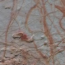 Enhanced-color view covering a 350 by 750 kilometer swath across the surface of Jupiter's moon Europa. The close-up combines high-resolution image data with lower resolution color data from observations made in 1998 by the Galileo spacecraft.