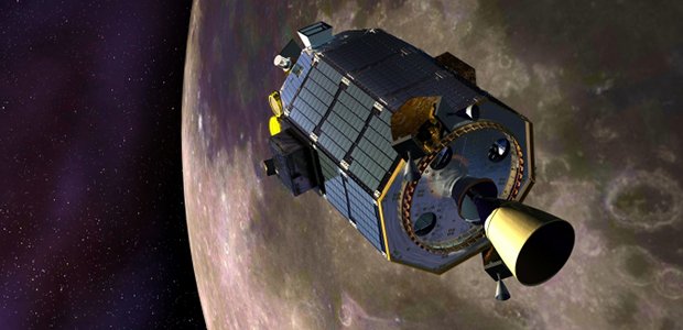 An artist's concept of NASA's Lunar Atmosphere and Dust Environment Explorer (LADEE) spacecraft orbiting the moon and preparing to fire its maneuvering thrusters to maintain a safe orbital altitude. Image credit: NASA Ames / Dana Berry